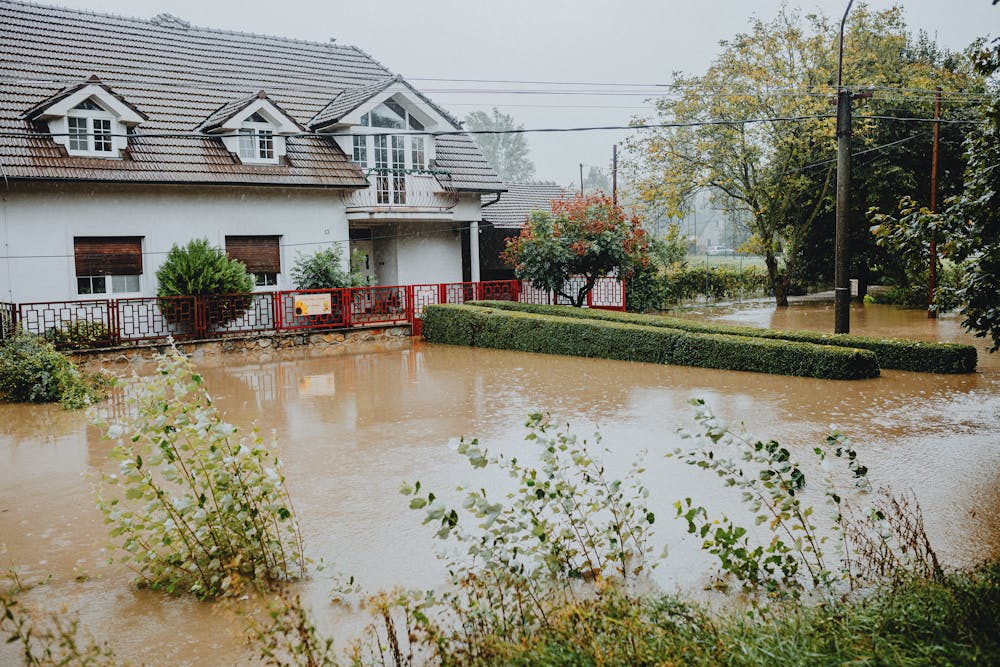 a flooded house and community